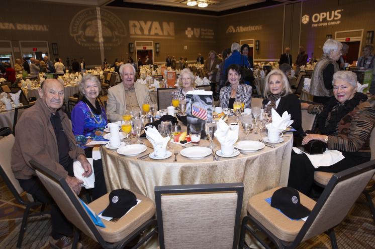 Group of people sitting around a table at a gala