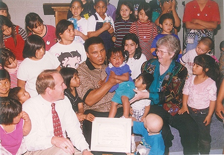 Boxing legend Muhammad Ali spends time with children in SVdP's dining room.