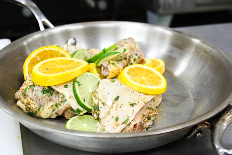 Prepping the chicken, citrus and herbs in a single pot