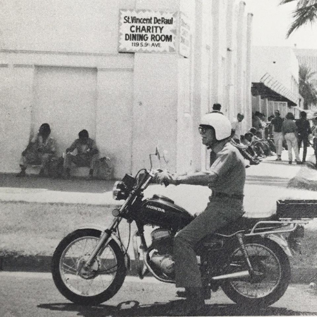 Chuck Wider, SVdP volunteer, rides his motorcycle to the dining room.