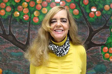 Ozanam Manor resident Karen smiles for a photo at SVdP's dental clinic.