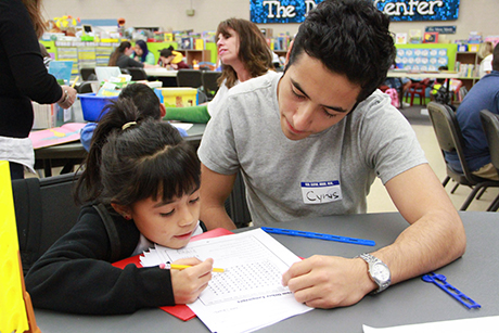 SVdP volunteer Cyrus Etebari tutors a child in the Dream Center.