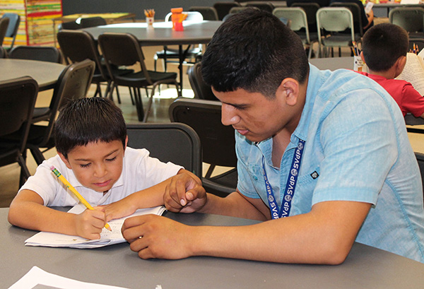 Daniel Monreal tutors a child in the Dream Center