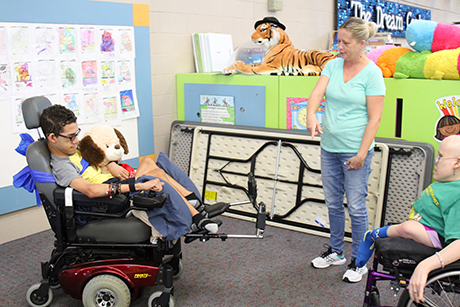 David drives his new wheelchair for the first time in SVdP's family dining room.