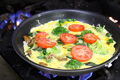 Chef Chris cooks a farm-fresh veggie frittata in SVdP's kitchen.
