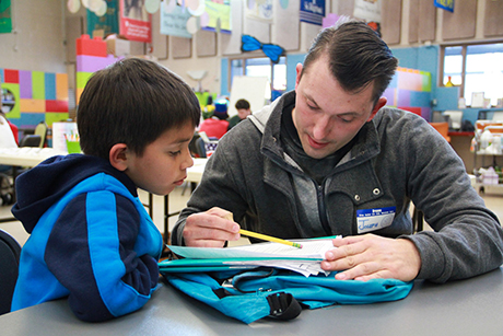 Joseph Kohn tutors a child in the Dream Center.