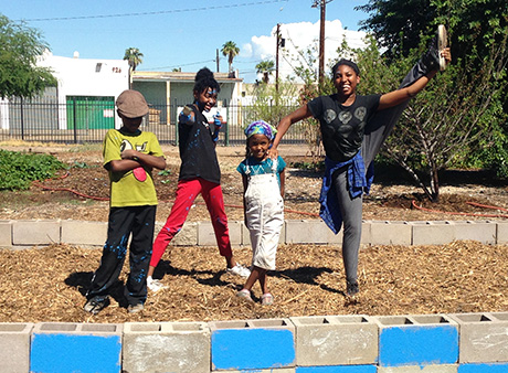 Selah, Serenity, Sahar and Saitara pose for a photo in the garden.