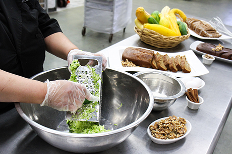 SVdP baker Theresa Alejo makes zucchini bread in the main kitchen.