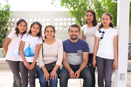 Jose poses for a photo with his mother and younger sisters at SVdP.