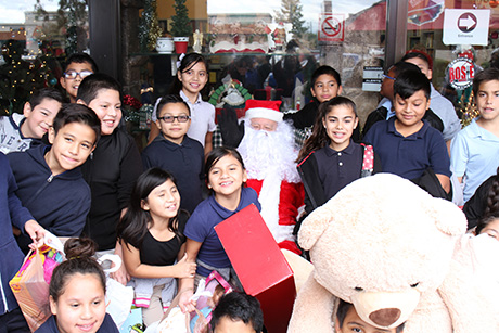 Children pose for a photo with Santa at the Palomino Christmas event.