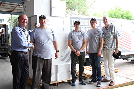 Plush & Loom staff and SVdP staff pose for a photo during the mattress delivery.