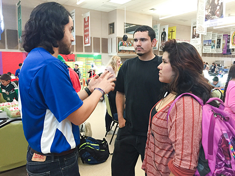 Volunteer Silvio Delgado talks to Dream Center students.