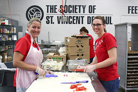 Wells Fargo employees volunteer in St. Vincent de Paul's kitchen.