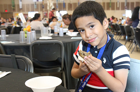A young boy enjoys his ice cream sandwich during the Wildflower Bread Kitchen Takeover.