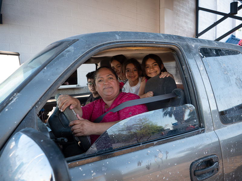 Rosa Guzman and the kids smile after going through the Family Dining Room drive-thru.