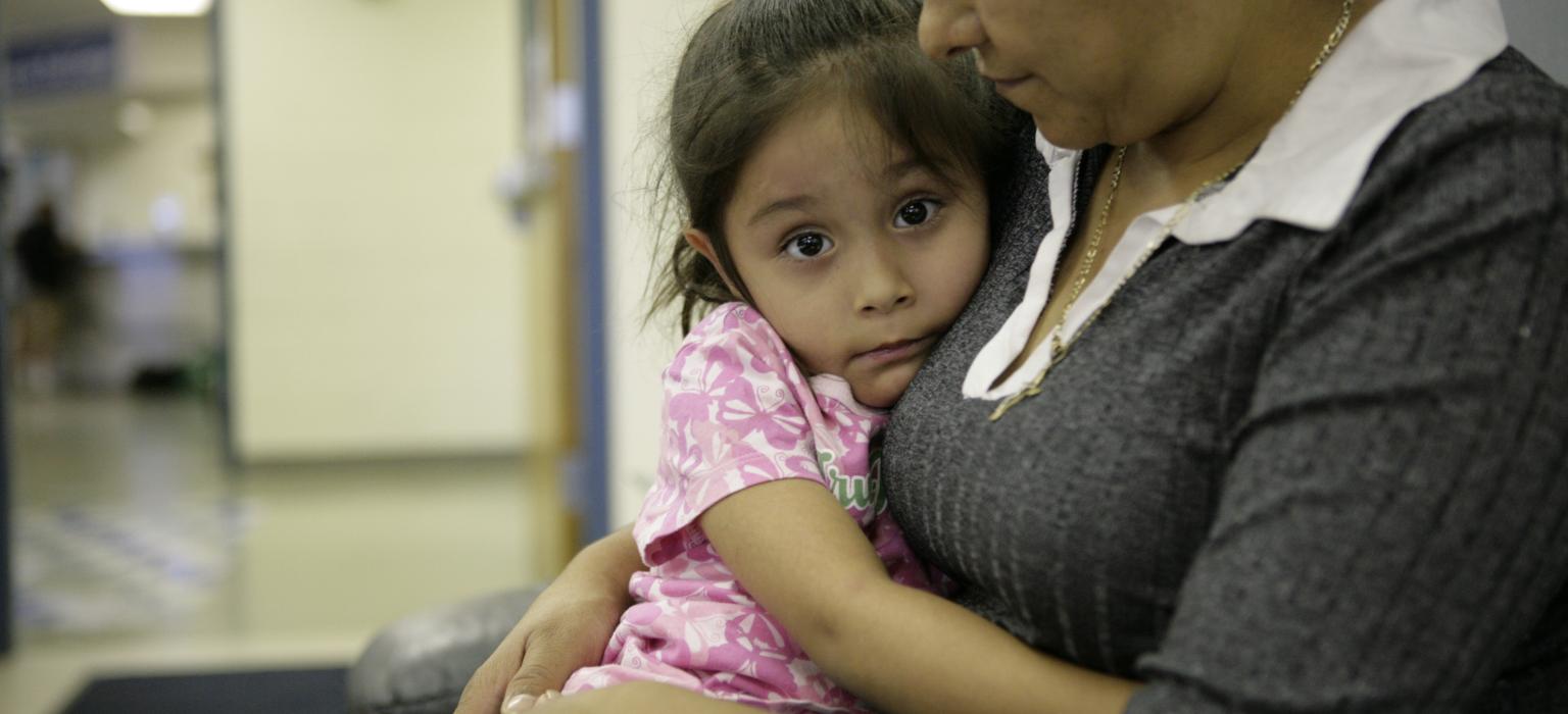 Homelessness Prevention Header Mom holding a young child