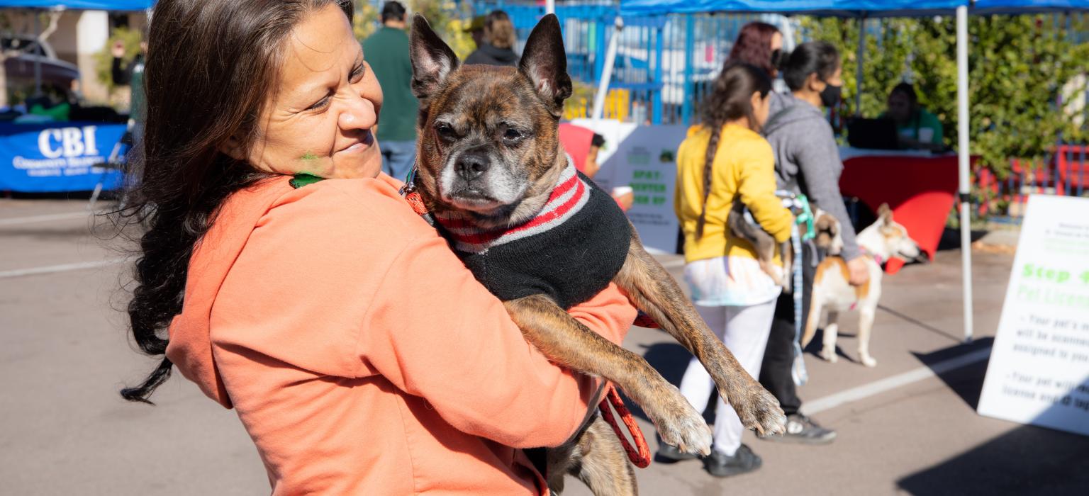 CAP Header Woman smiling holding her dog