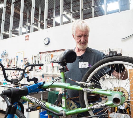 Man checking the wheel of a bike