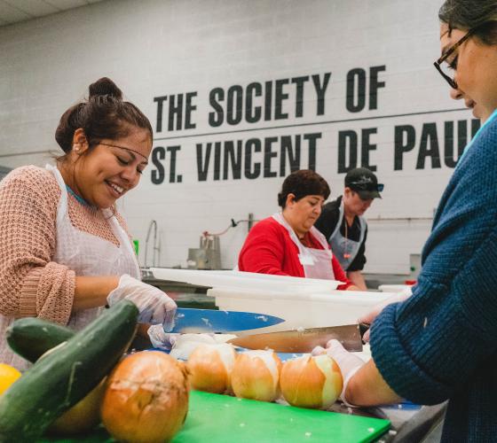 Kitchen VSO Header Two women smiling and chopping vegetables