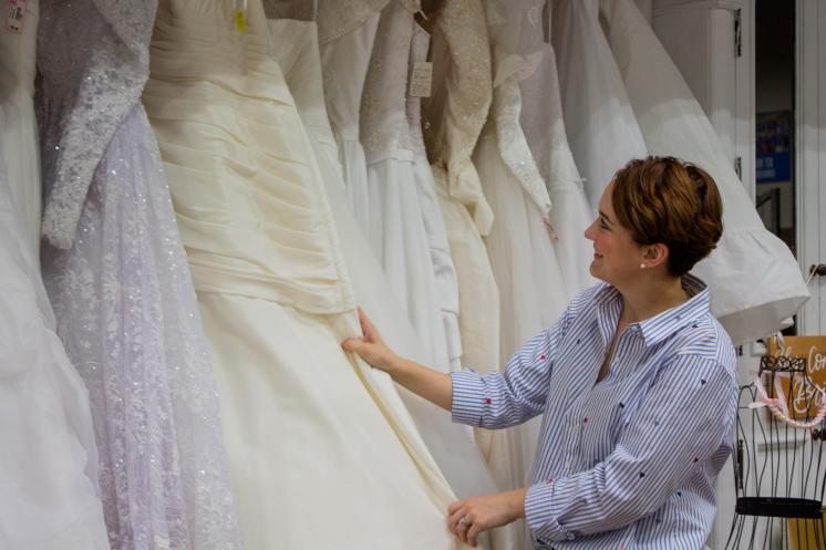 Mackenzie sorting through wedding dresses 