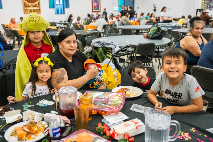 A family poses for a photo in SVdP's Family Evening Meal.