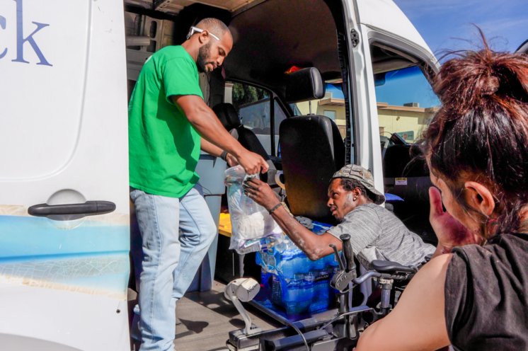 A St. Vincent de Paul employee distributes water to those experiencing homelessness via the Water Truck Program.
