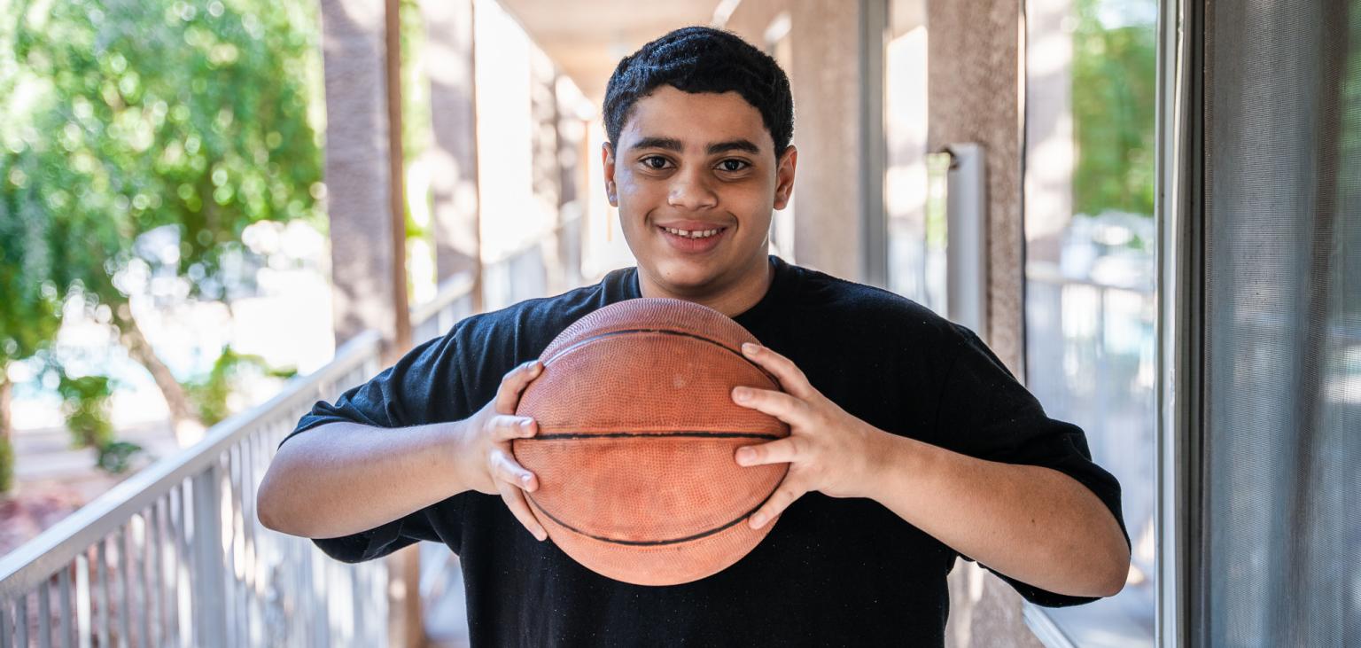 Jehrique holds the basketball given to him by SVdP.