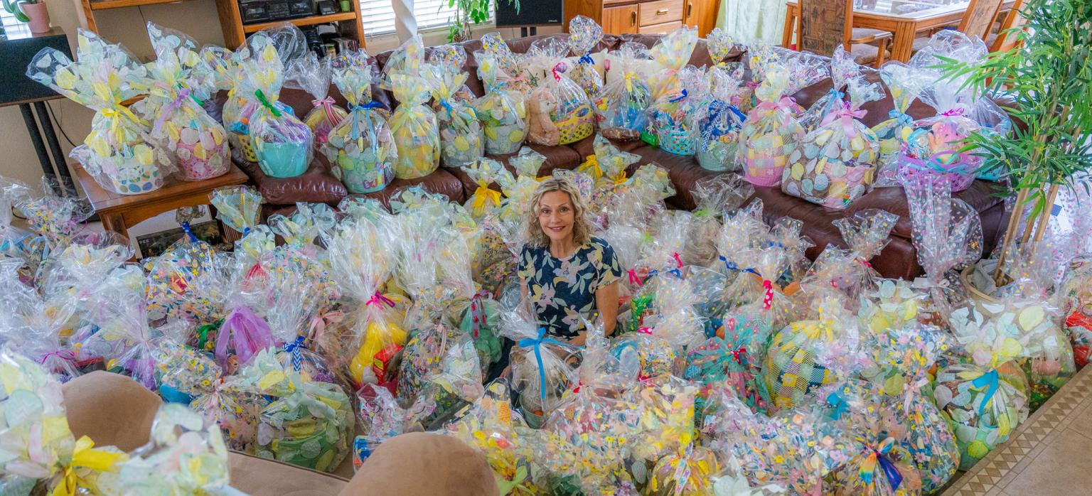 Debi sits among the dozens of Easter baskets she helped organize the making of.