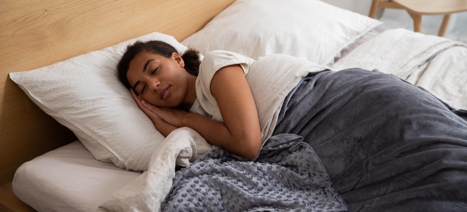 A woman sleeps in her bed.