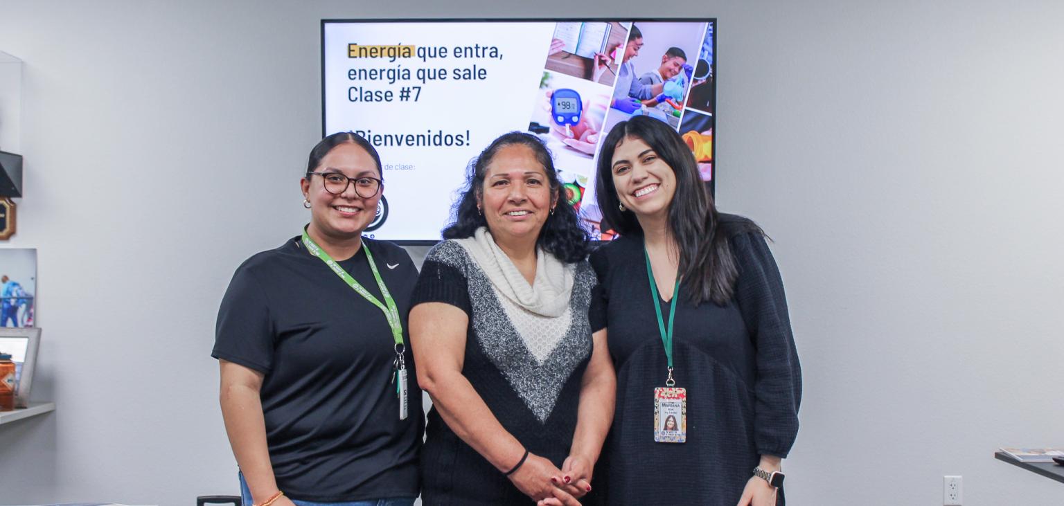 Maria stands with the course instructors from SVdP.
