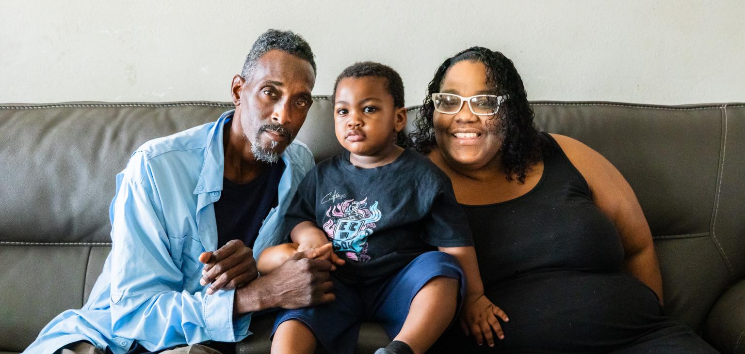 Marc and Caprise pose with their son, Pharaoh in between them.