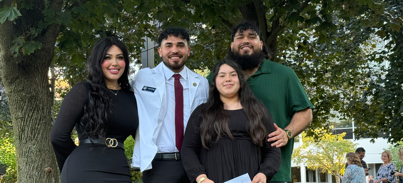Russvel poses with his family after his white coat ceremony.