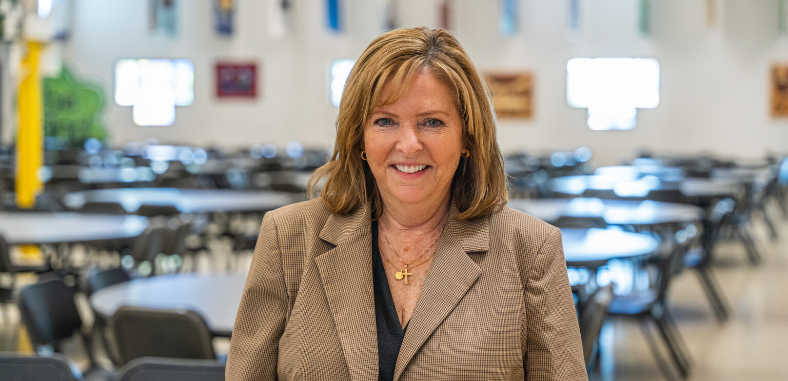 Libby Ekre poses in SVdP's Hall of Banners.