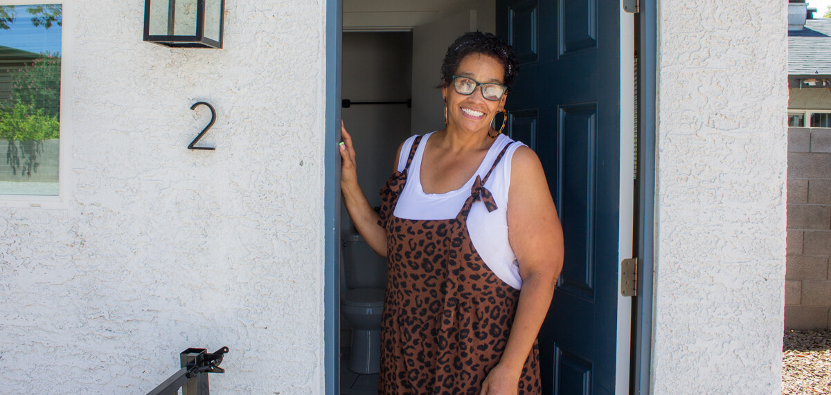 Annamarie in front of her new home.