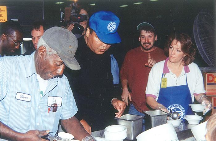 Muhammad Ali helps serve in SVdP's dining room.