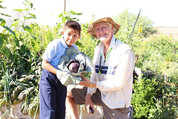 Sebastian from the Dream Center poses for a photos with SVdP urban farm director, David Smith.