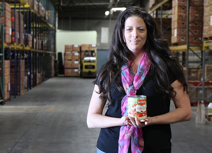 Jamie Bethune poses for a photo in SVdP Food Rec Warehouse