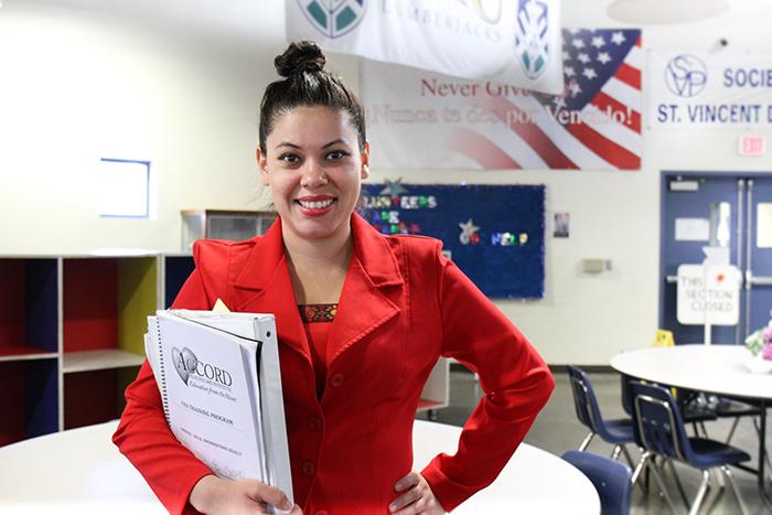 Jasmine poses for a photo in SVdP's downtown Phoenix dining rom.