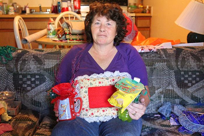 Sherry poses for a photo with her crafts.