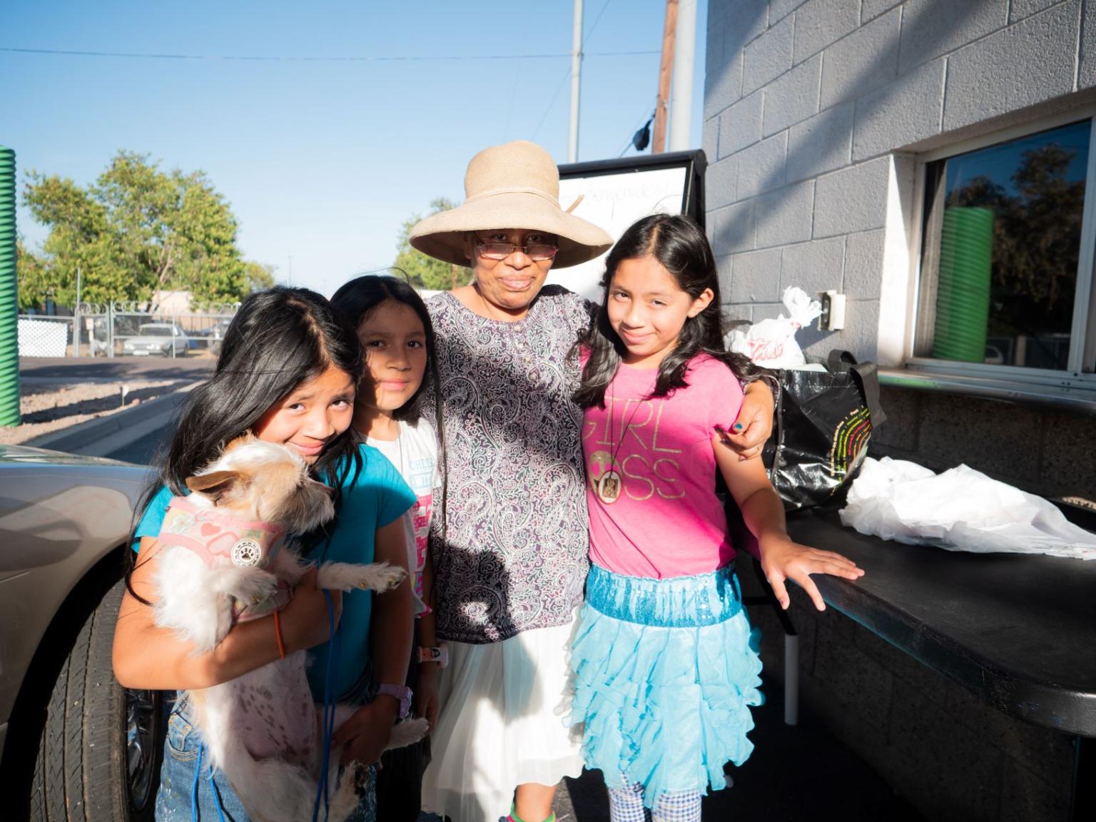 Lucia and her daughters at the SVdP drive-thru out of which the Family Dining Room and Dream Center operate.