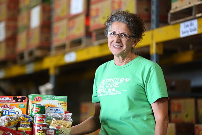 Mary Thomas, SVdP food warehouse manager, poses for a photo in the food warehouse.