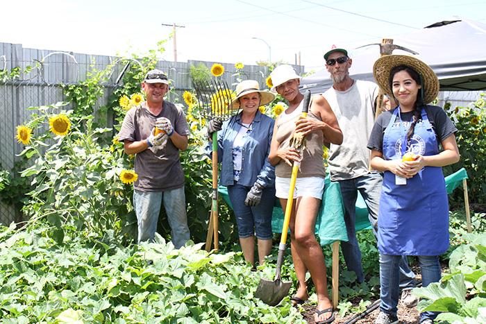 Volunteers pose for a photo at the Mesa Dining Room urban farm.