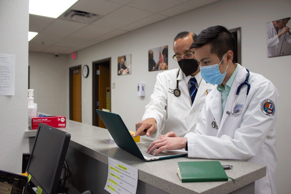 Dr. John Anwar, SVdP medical director and Creighton University assistant professor, mentors a Creighton medical student during a volunteer clinic.