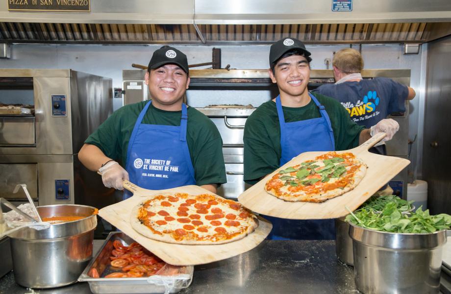 Volunteers serving pizza