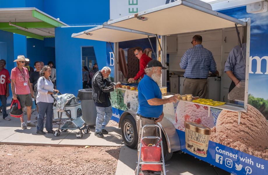 A line of guests at SVdP's Phoenix Dining Room await their turn to get ice cream from the Blue Bell Ice Cream refrigerated trailer.