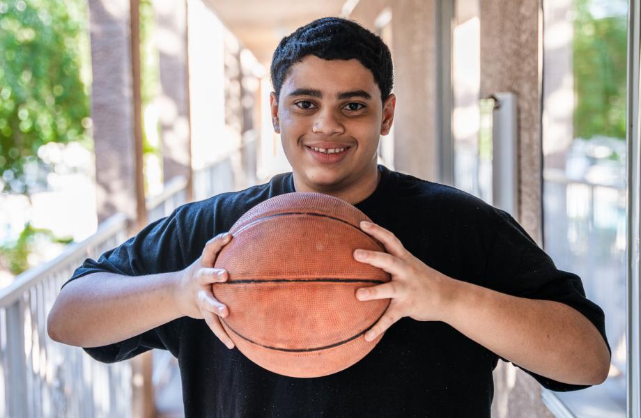 Jehrique holds the basketball given to him by SVdP.