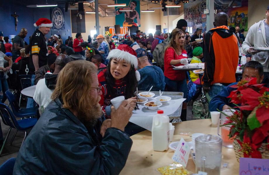 Christmas Volunteer handing out hot meal