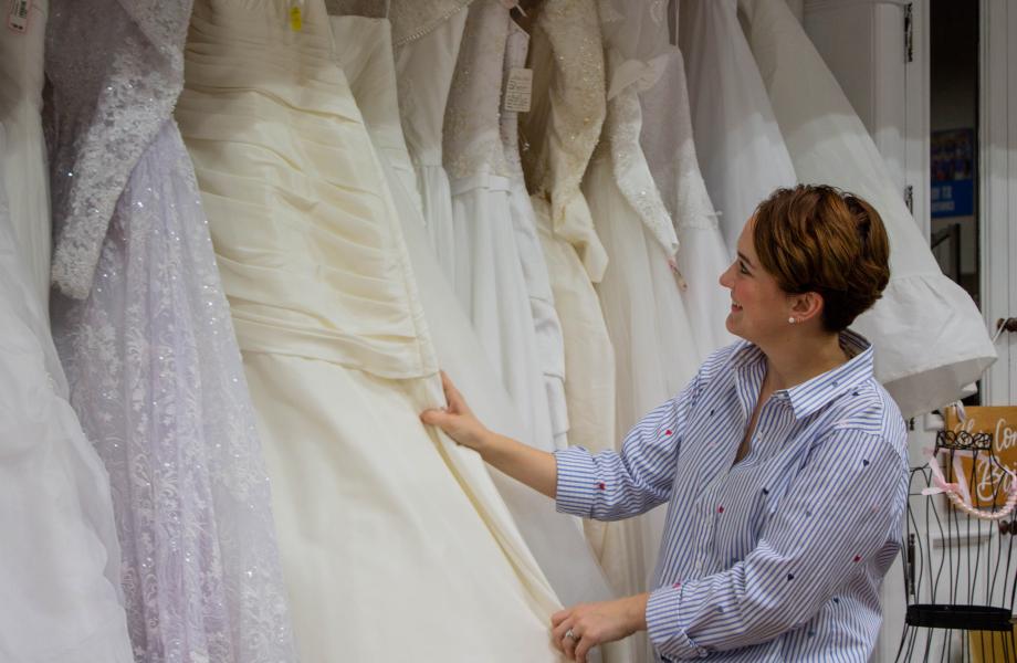 Mackenzie sorting through wedding dresses 