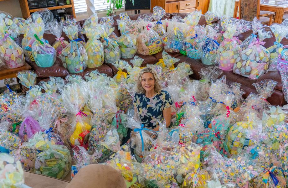 Debi sits among the dozens of Easter baskets she helped organize the making of.