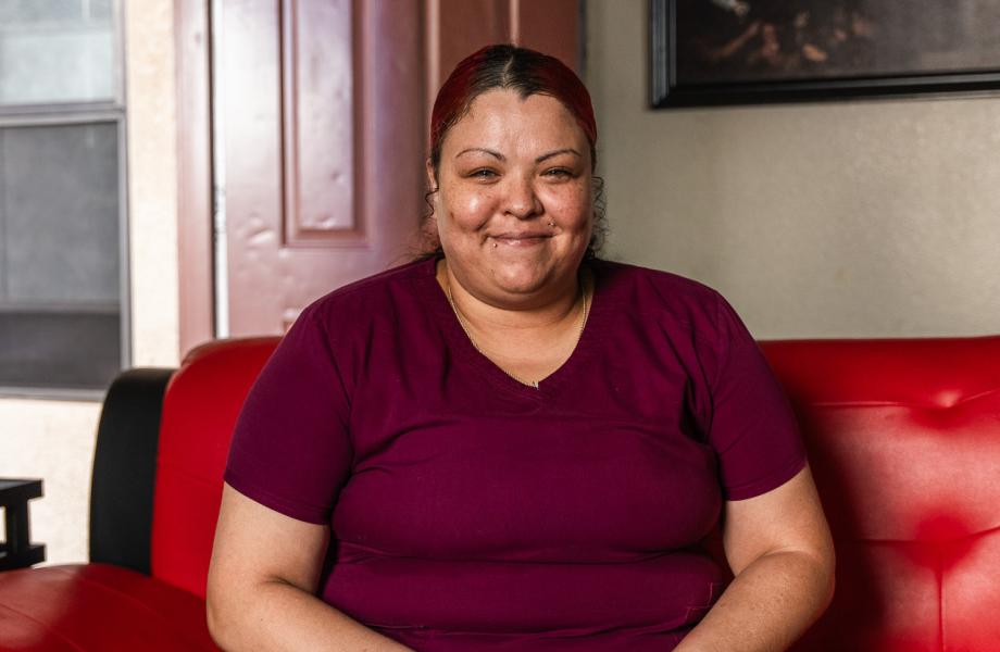 Angela Bryant smiles for a photo in her home.